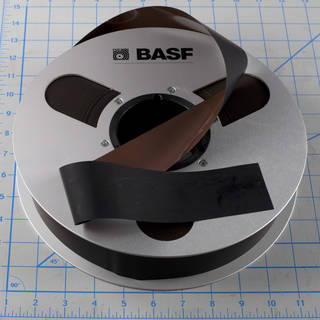 Two-inch open reel audio tape photographed with measurement for scale