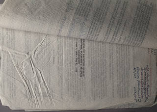 Carbon copy on wrinkled manifold paper in raking light