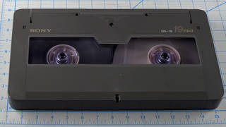 D-1 cassette pictured with ruler for scale