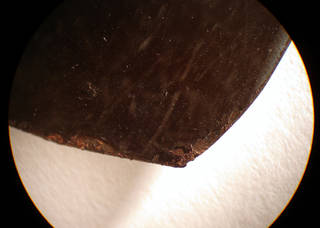 Tintype under microscope - flaking lacquer